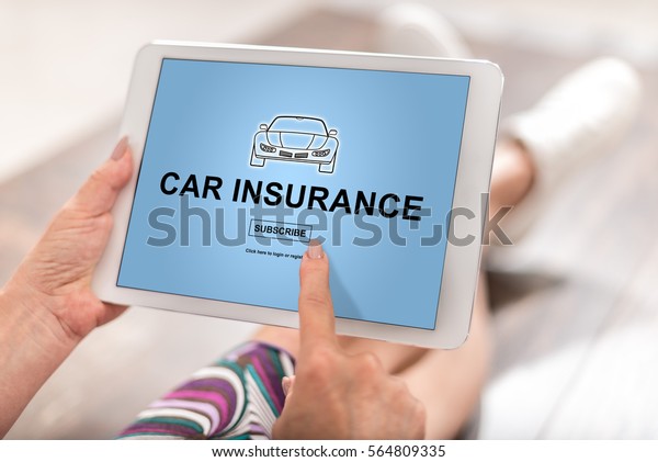 Woman using a\
tablet with car insurance\
concept