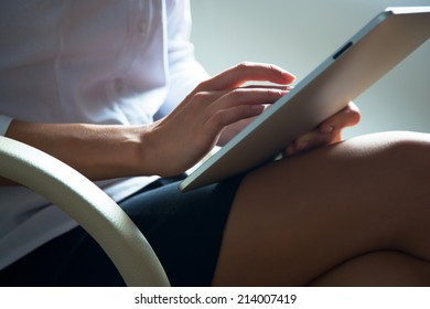 Woman using a tablet computer. Close up.