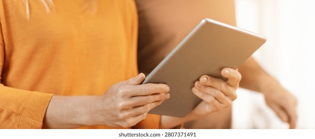 Woman Using Tablet With Focused Expression At Home, Modern Lifestyle Concept