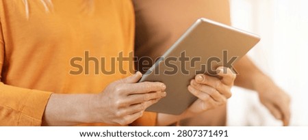 Woman Using Tablet With Focused Expression At Home, Modern Lifestyle Concept