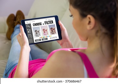 Woman using tablet at home against smartphone app menu