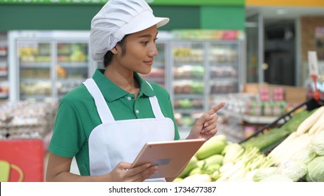 Woman using tablet to inspect products within department.  - Powered by Shutterstock