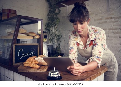 Woman using tablet for online business order - Powered by Shutterstock