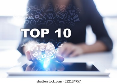 Woman is using tablet pc, pressing on virtual screen and selecting top 10.