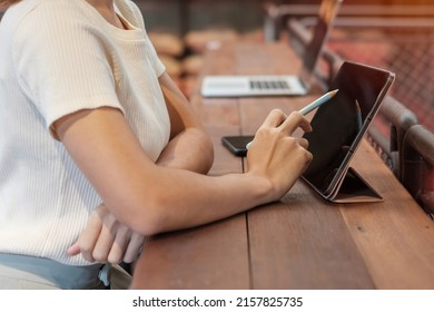 woman using tablet for sms messages, hand holding pencil typing touchscreen mobile phone in cafe or modern office. lifestyle, technology, Social media and network concept