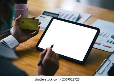 Woman Using Tablet While Holding Credit Card To Pay Online, White Screen Display For Your Ads Product Montage.