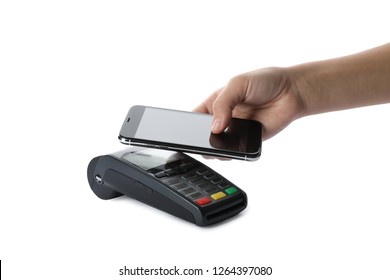 Woman using terminal for contactless payment with smartphone on white background