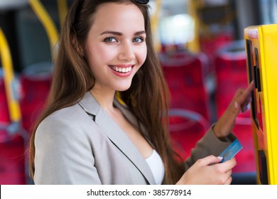 Woman Using Ticket Machine On Bus
