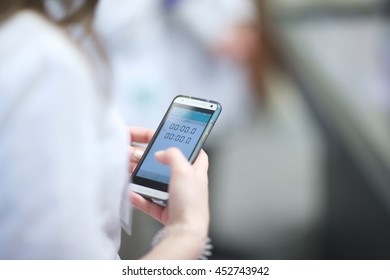 Woman Using Timer App On Her Smart Phone