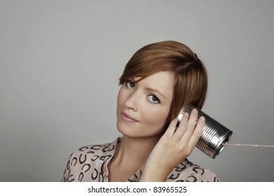 woman using a tin can to communicate