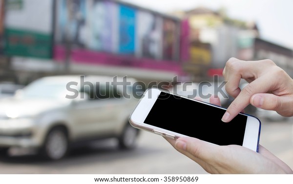 Woman using touch screen mobile phone with blur\
Traffic car on the road