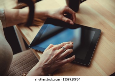 Woman using a touch screen tablet hands close up - Shutterstock ID 1359920984