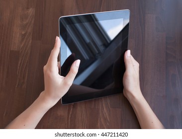 Woman using a touch screen tablet hands close up.