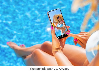 Woman using video sharing social media app on mobile phone while sitting by the pool - Shutterstock ID 2117292680