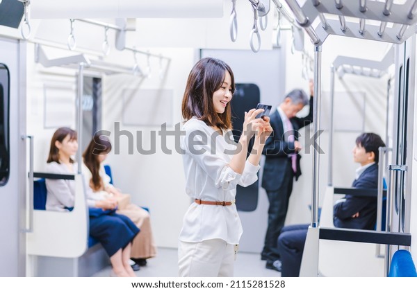 A woman\
using a video streaming service on a\
train
