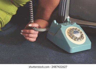 woman using vintage rotary phone - Powered by Shutterstock