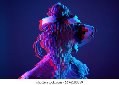 Woman is using virtual reality headset. Neon light studio portrait. Concept of virtual reality, simulation, gaming and future technology. Image with glitch effect.
