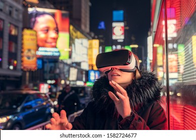 Woman using virtual reality in Time Square, New York - Powered by Shutterstock