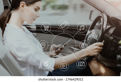 Woman Using Voice Search On Phone Driving Sitting In Smart Car. Modern Technology Services. Selective Focus