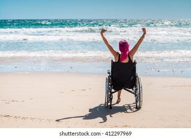 Woman using wheelchair at the beach - Powered by Shutterstock