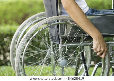 woman using a wheelchair in a park