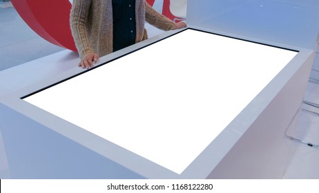 Woman using white blank touchscreen display terminal at modern technology show. Mock up and technology concept - Shutterstock ID 1168122280