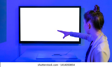 Woman Using White Empty Interactive Display With No Touch Control At Modern Technology Exhibition. Mock Up, Template, Motion Capture, Future And Technology Concept