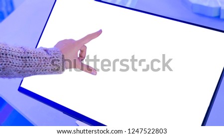 Woman using white empty interactive touchscreen display at modern technology exhibition - close up shot. Mock up, template, education, future and technology concept