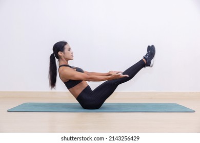 Woman With V Sit Pose On A Yoga Mat In A Fitness