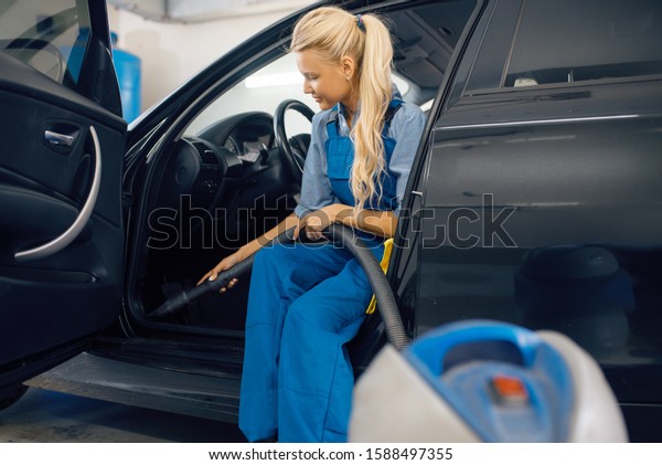 Woman with vacuum\
cleaner, car wash service