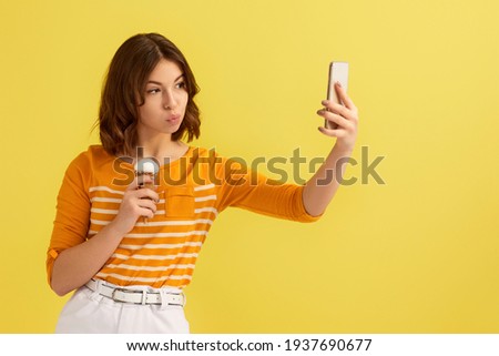 woman with vanilla ice cream making selfie