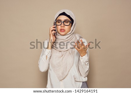     woman in a veil with glasses talking on the phone                          