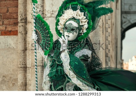 Woman in venetian carnival emerald outfit