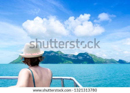 Woman in vessel going to island, tropical sea travel concept.