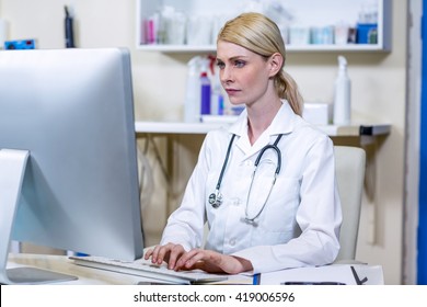 A Woman Vet Working With Her Computer At Medical Office