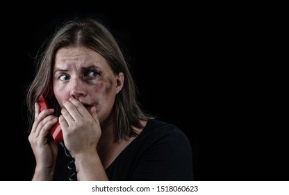 Woman Victim Of Domestic Violence And Abuse Asks For Help By Phone. Empty Space For Text. Isolated On Dark Background