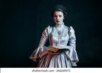 Woman In Victorian Dress Imprisoned In A Dungeon