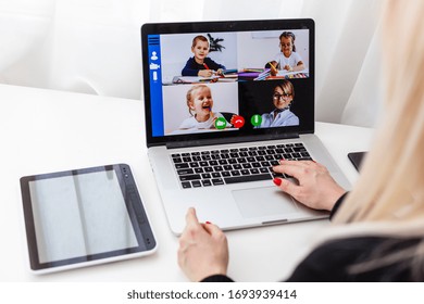 Woman video conferencing with tutor on laptop at home. Distance education concept. - Shutterstock ID 1693939414