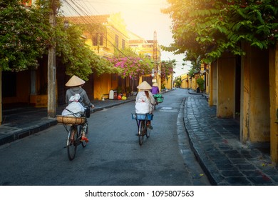 Woman Vietnam Riding Bicycle  On During Sunrise,Hoian Vietnam