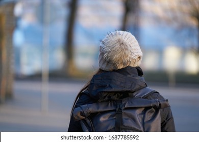 woman view from back, dressed in knitted hat with pompom. - Shutterstock ID 1687785592