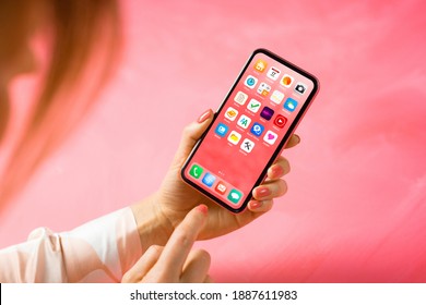 Woman viewing home screen with app icons of the mobile phone - Shutterstock ID 1887611983