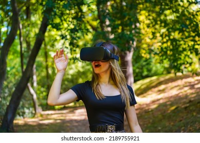 Woman With Virtual Reality Glasses Enjoying Nature Seeing Things In The Glasses