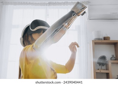 A woman in a virtual reality headset touches a robotic prosthesis bathed in sunlight in a modern home environment, recalling the combination of everyday life and advanced technology. Futuristic