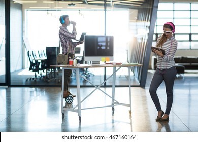 Woman in virtual reality video glass using digital tablet at office - Powered by Shutterstock