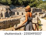 A woman visiting the archaeological ruins of the Butrint or Butrinto National Park in Albania