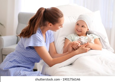 Woman visiting her daughter who is undergoing course of chemotherapy in clinic. Childhood cancer awareness concept - Shutterstock ID 1901756146