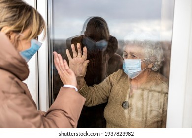Woman Visiting Her Grandmother In Isolation During A Coronavirus Pandemic
