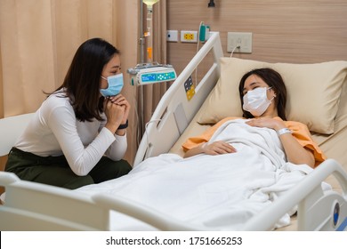 woman visiting and take care female patient on a bed at hospital. people must be wearing medical mask to prevention coronavirus(covid-19) pandemic.