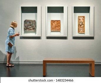 Woman Visitor Looking Pictures In Art Gallery Museum