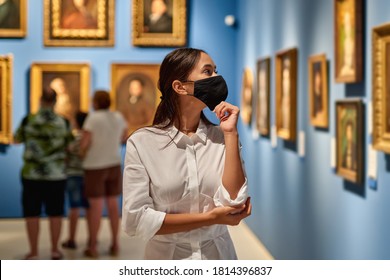 Woman Visitor Wearing An Antivirus Mask In Museum Looking At Pictures